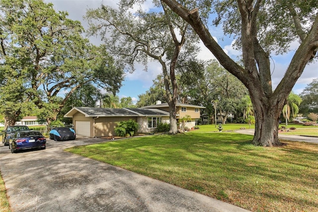 view of front of home with a front lawn and a garage