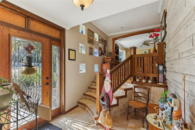 foyer entrance featuring light tile patterned floors, ceiling fan, and ornamental molding