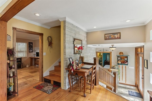 dining room featuring light wood-type flooring and crown molding