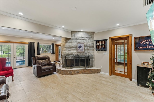 living room featuring ornamental molding, a fireplace, and french doors