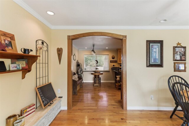 hall featuring crown molding and light wood-type flooring