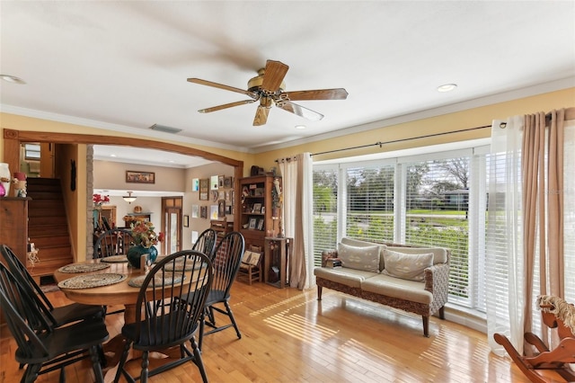 dining space featuring light hardwood / wood-style floors, ceiling fan, and ornamental molding