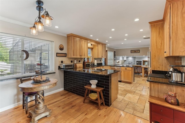 kitchen with kitchen peninsula, decorative light fixtures, tasteful backsplash, and dishwasher