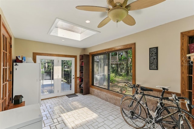 sunroom with ceiling fan, french doors, and a skylight