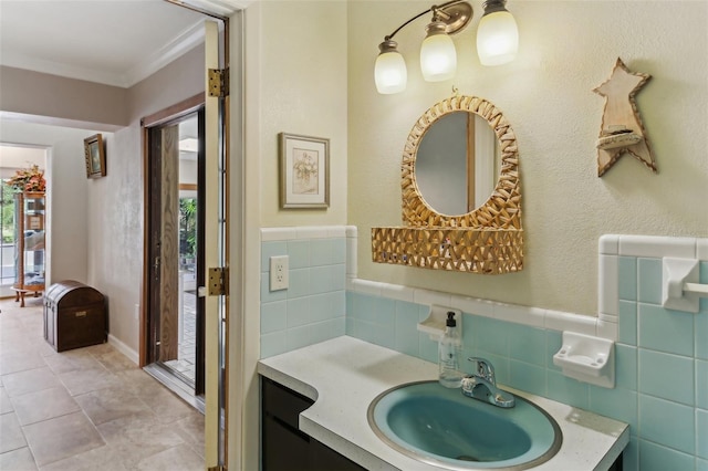 bathroom with vanity, tile walls, and ornamental molding