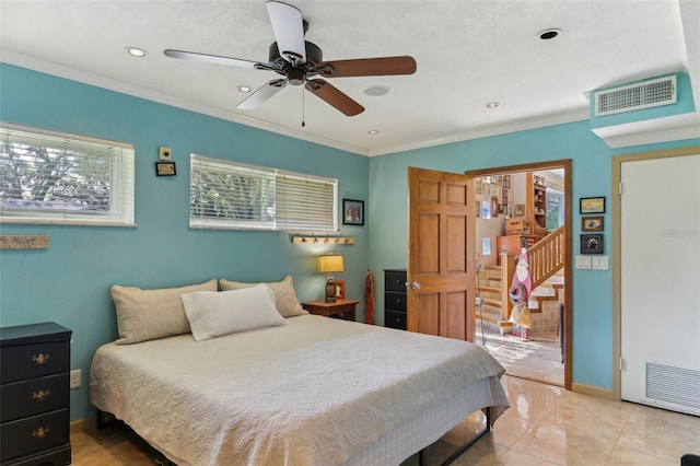 tiled bedroom featuring ceiling fan and crown molding