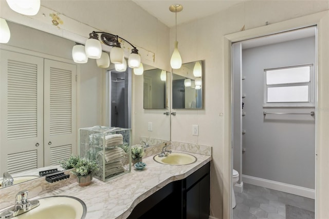 bathroom featuring tile patterned floors, vanity, and toilet