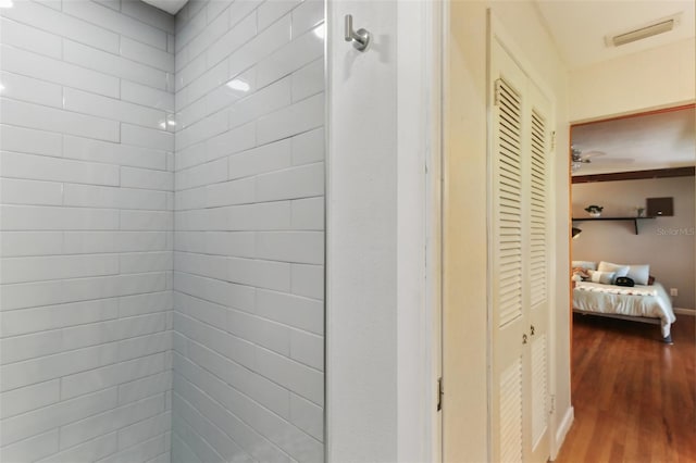 interior space featuring hardwood / wood-style floors and a shower