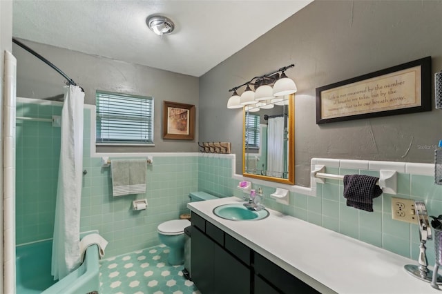 bathroom featuring a shower with curtain, vanity, and tile walls