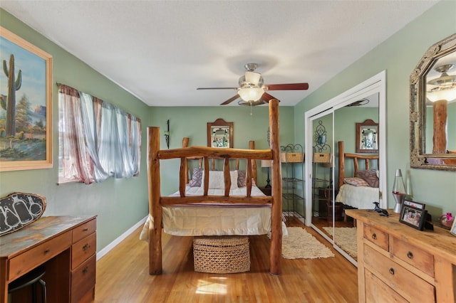 bedroom with a closet, light hardwood / wood-style flooring, and ceiling fan