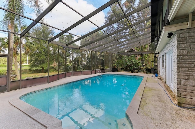 view of swimming pool with a lanai