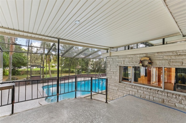 view of swimming pool with a patio and a lanai