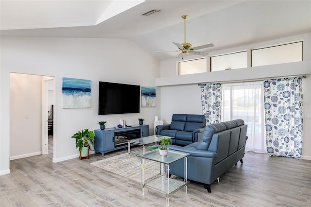 living room featuring wood-type flooring, ceiling fan, and lofted ceiling