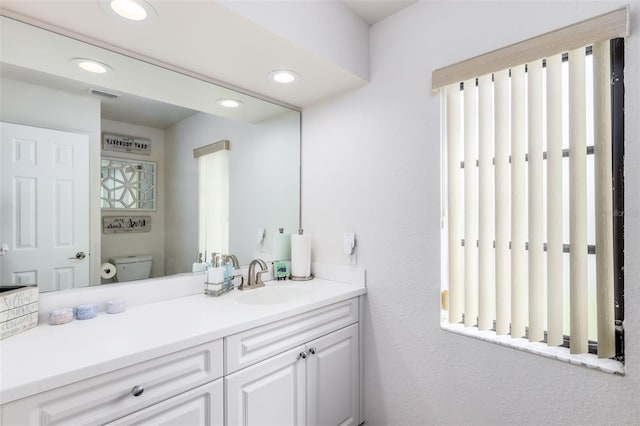 bathroom featuring vanity and toilet