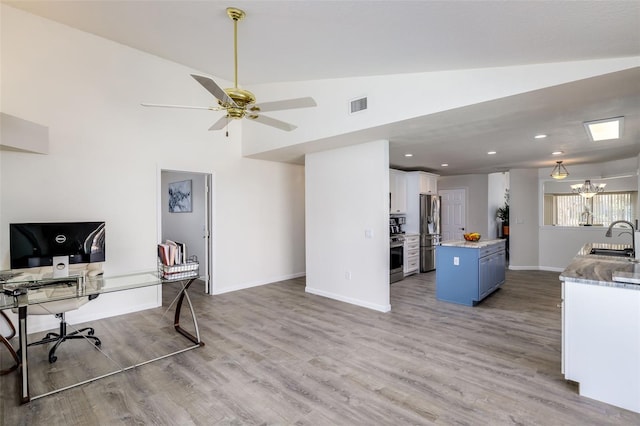 office space with ceiling fan, wood-type flooring, sink, and vaulted ceiling