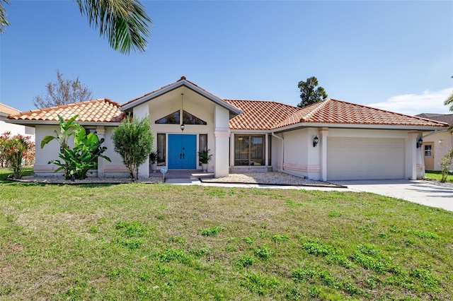 mediterranean / spanish home with a front lawn and a garage