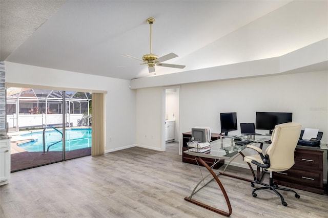 office area with ceiling fan, light hardwood / wood-style floors, and lofted ceiling