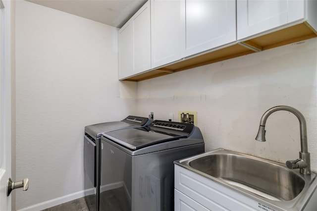 washroom featuring cabinets, dark hardwood / wood-style flooring, separate washer and dryer, and sink