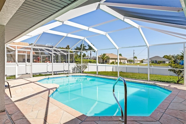 view of swimming pool featuring glass enclosure and a patio