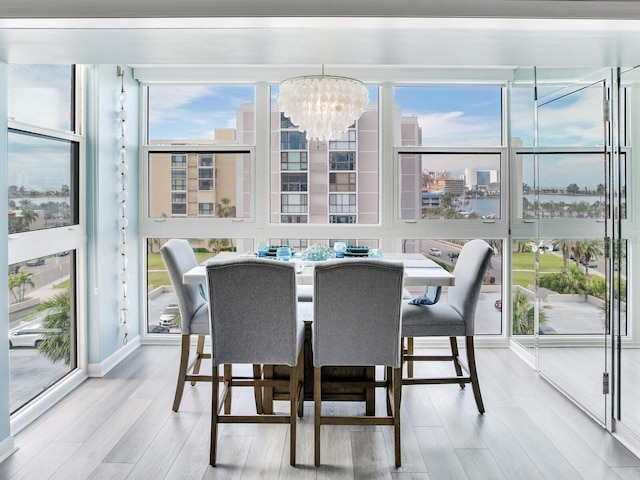 sunroom / solarium with a chandelier