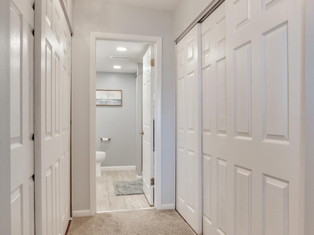 hallway with light carpet