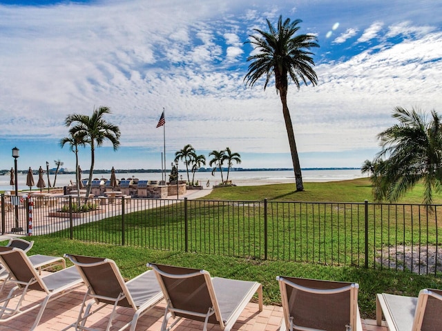 view of patio / terrace featuring a water view and a beach view