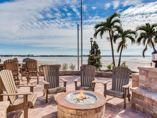 view of patio / terrace with a water view and an outdoor fire pit