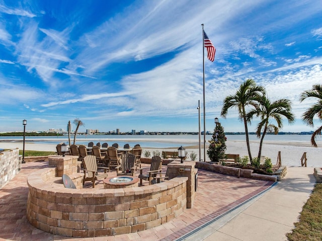 view of patio featuring a water view and an outdoor fire pit