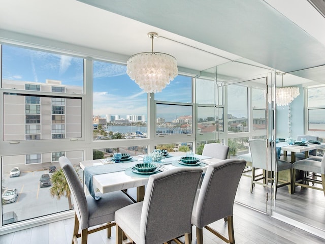 sunroom / solarium featuring an inviting chandelier