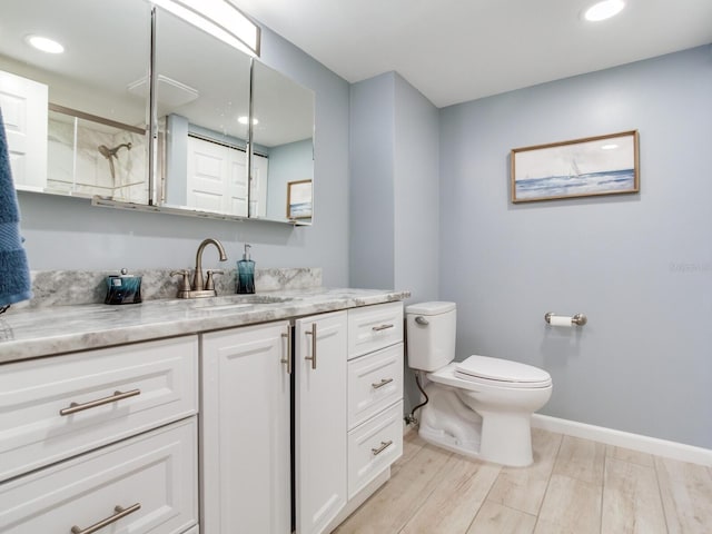 bathroom featuring hardwood / wood-style floors, vanity, and toilet