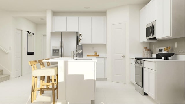 kitchen with stainless steel appliances, white cabinetry, and a kitchen island with sink