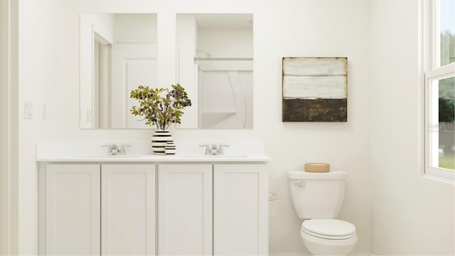 bathroom with vanity, toilet, and walk in shower