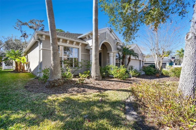 view of front of property with a front yard and a garage