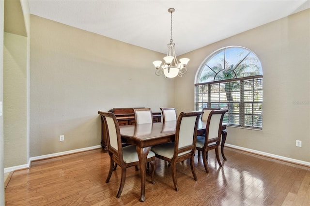 dining space featuring a notable chandelier and wood-type flooring