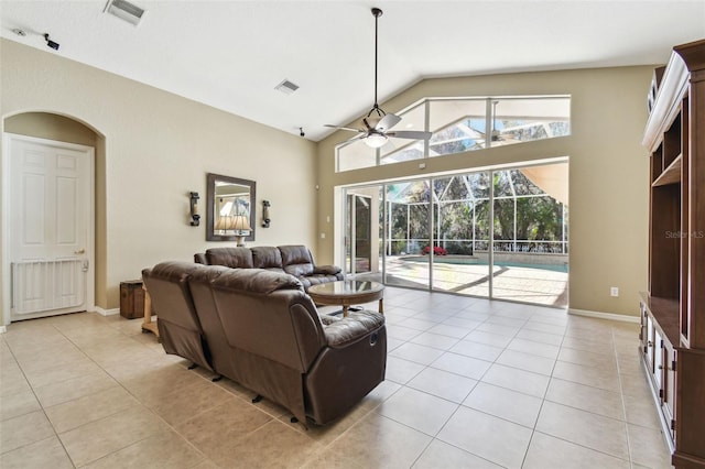 tiled living room featuring ceiling fan and vaulted ceiling