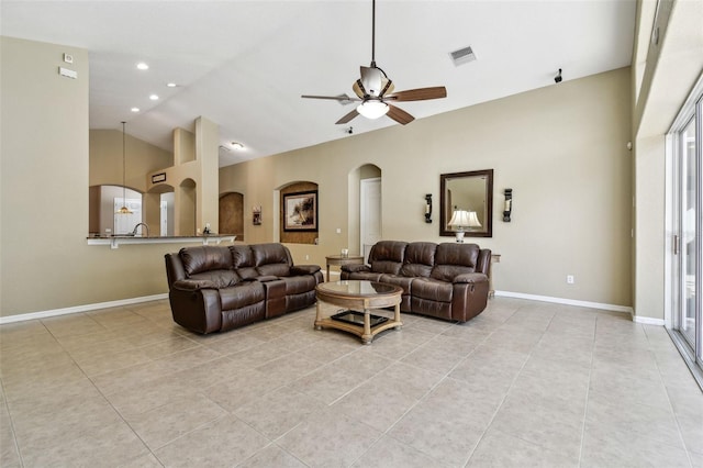 living room featuring light tile patterned floors, vaulted ceiling, and ceiling fan