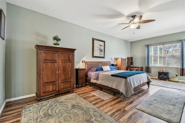 bedroom featuring ceiling fan and dark wood-type flooring