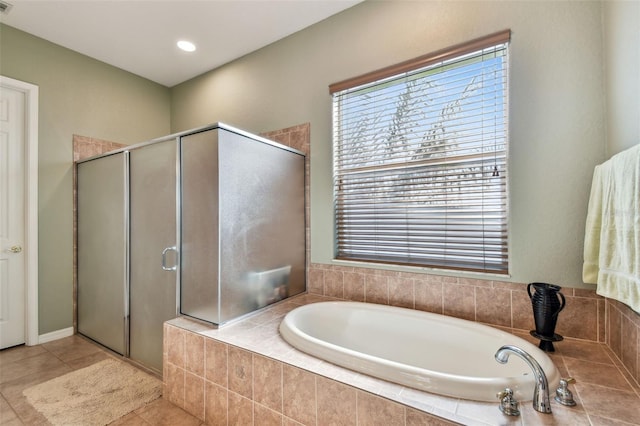 bathroom featuring tile patterned flooring and shower with separate bathtub