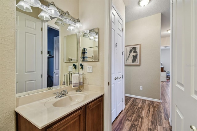 bathroom featuring vanity, a textured ceiling, and hardwood / wood-style flooring