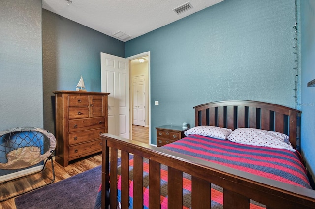 bedroom with hardwood / wood-style flooring