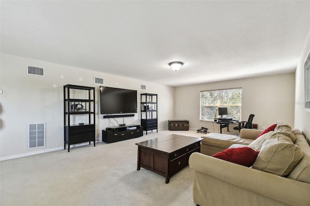 carpeted living room featuring a textured ceiling