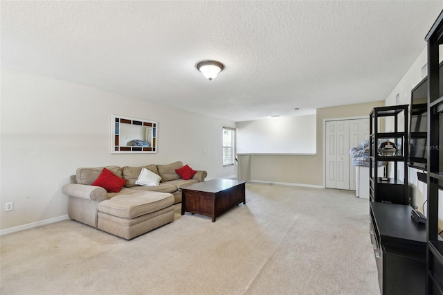 living room with light colored carpet and a textured ceiling