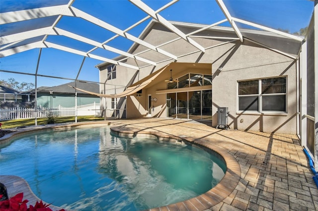 view of pool with a lanai, a patio area, and ceiling fan