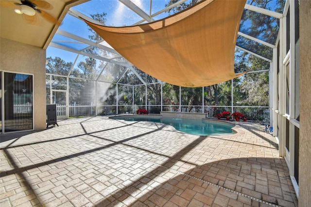 view of pool featuring ceiling fan, a patio area, and glass enclosure