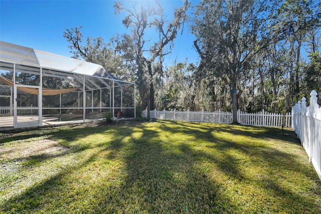 view of yard with a pool and glass enclosure