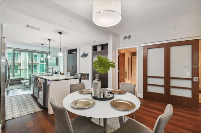 dining area with dark wood-type flooring and sink