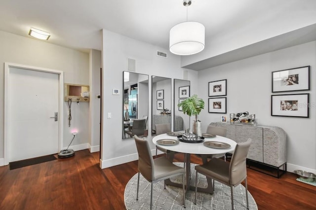 dining area with dark wood-type flooring