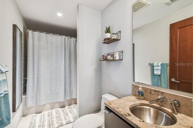 full bathroom featuring shower / bath combination with curtain, vanity, and toilet