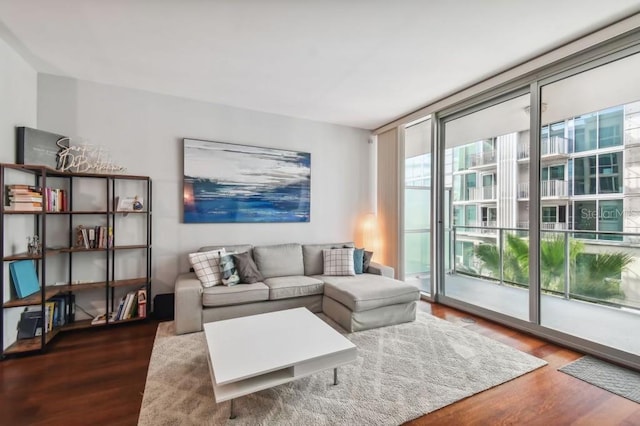 living room with expansive windows and hardwood / wood-style flooring