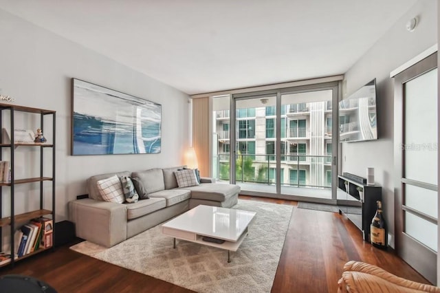 living room featuring floor to ceiling windows and dark hardwood / wood-style floors